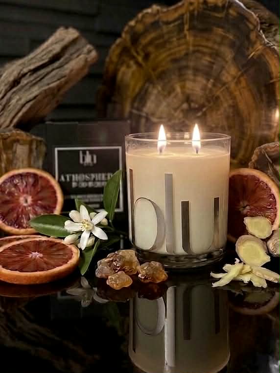 Candle with decorative elements on a reflective surface