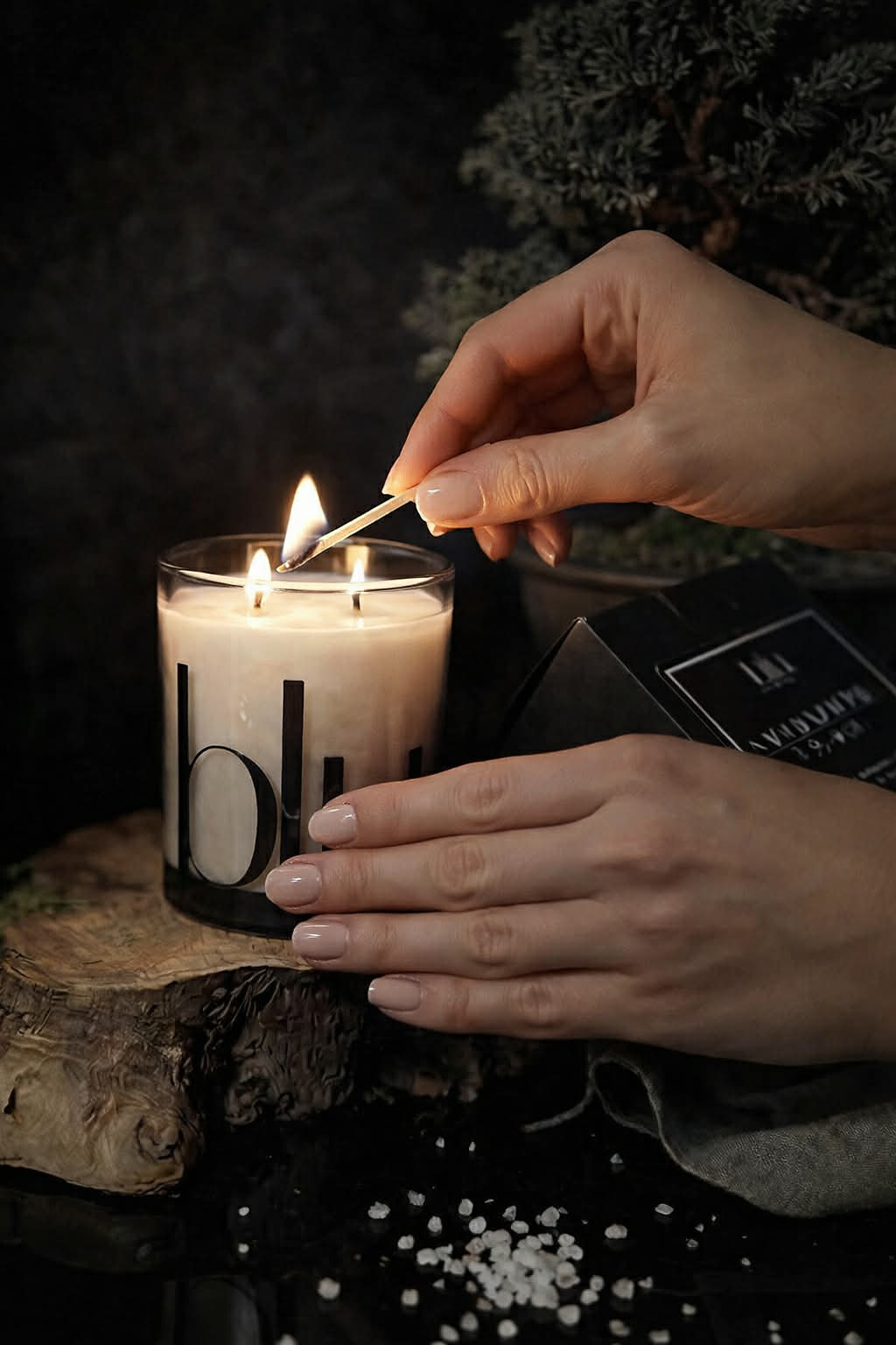 A lit Gravity artisan candle on a modern desk, providing a grounded home fragrance to help focus and quiet the chaos