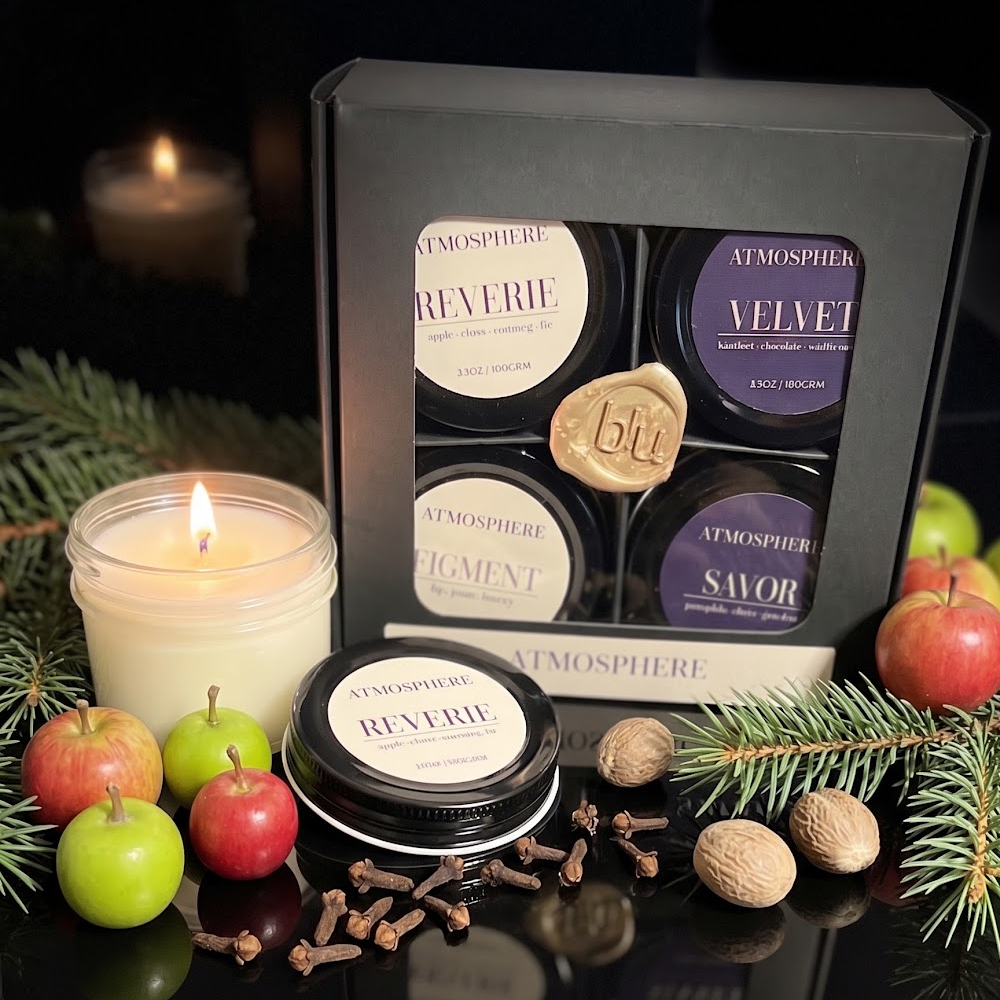 Reverie spiced orchard candle from the autumn candle discovery set styled with mini apples and pine needles