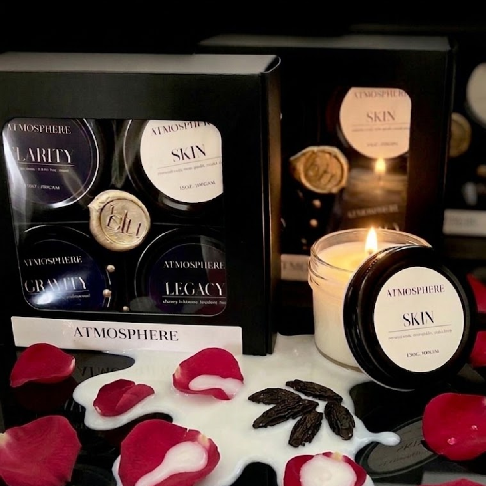 Skin artisan candle from The Icons Discovery Set styled with rose petals and tonka