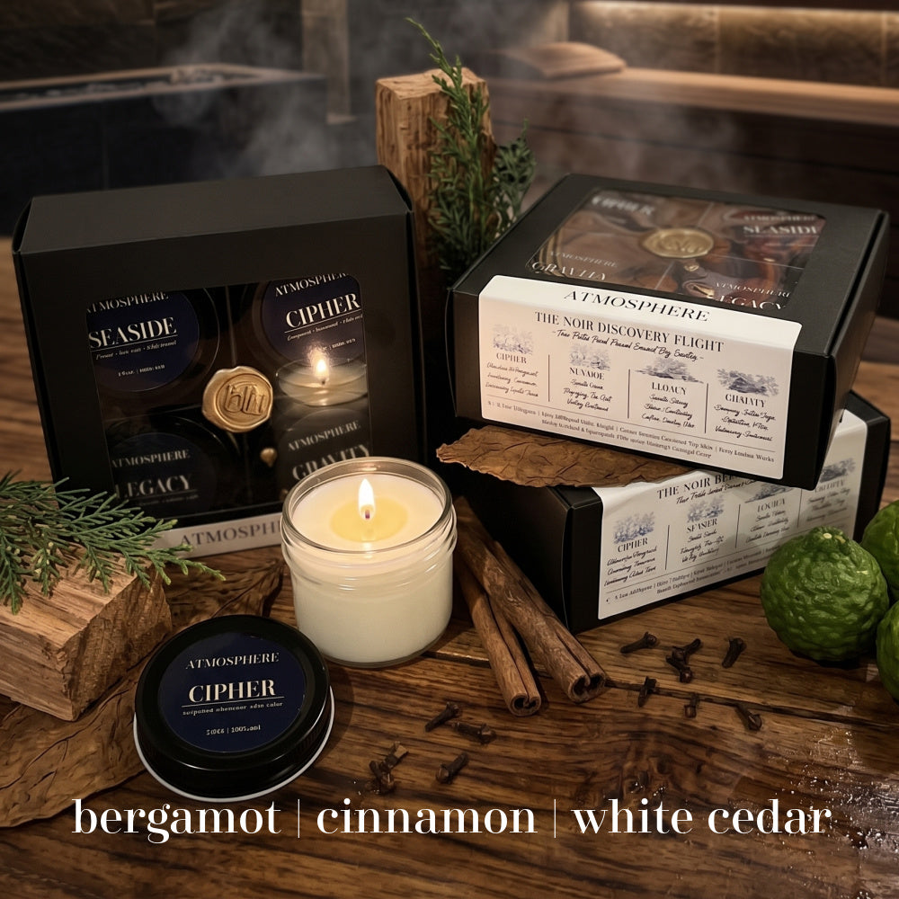 Seaside and Cipher candles from The Noir Discovery Set styled with driftwood and leather